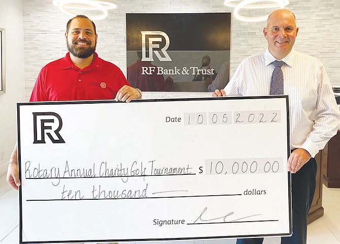 SHOWN, left to right, are Christian Knowles, vice president and director of funding at Rotary Club of
East Nassau, and David Van Onselen, RF vice president of financial advisory services.